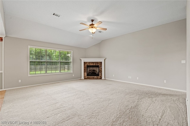 2419 Shealei Cir, Alma, AR 72921 - unfurnished living room featuring a ceiling fan, a fireplace, vaulted ceiling, and light carpet