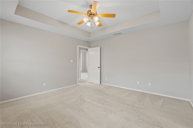 2419 Shealei Cir, Alma, AR 72921 - spare room with a tray ceiling, carpet, and a ceiling fan