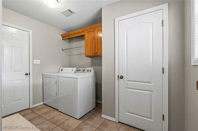 2419 Shealei Cir, Alma, AR 72921 - laundry room featuring washer and dryer, cabinet space, light tile patterned floors, and a textured ceiling