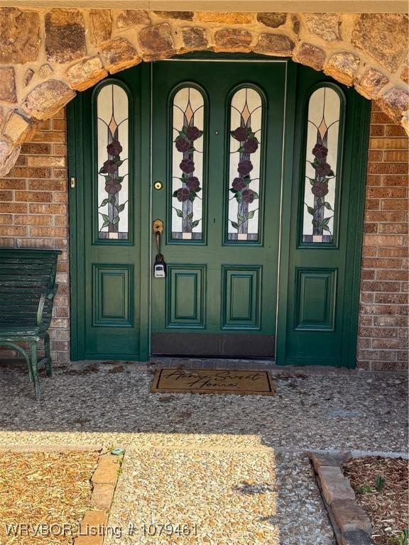 property entrance with brick siding