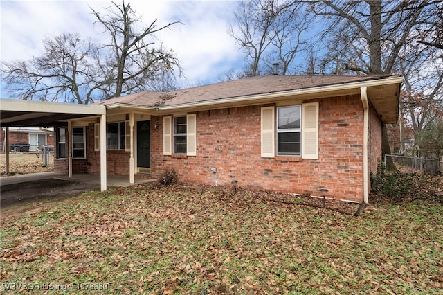 rear view of property with a carport