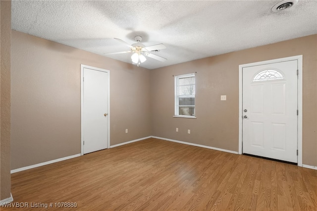 entryway featuring ceiling fan, a textured ceiling, and light wood-type flooring