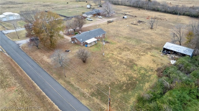 birds eye view of property with a rural view