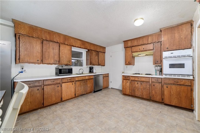 kitchen with sink, stainless steel appliances, and a textured ceiling