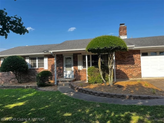 single story home with a front yard and a garage