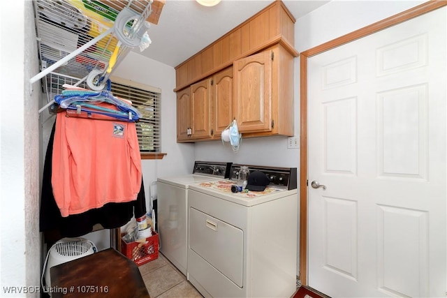 clothes washing area featuring cabinets, light tile patterned floors, and separate washer and dryer