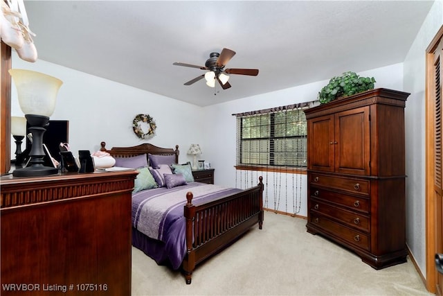 carpeted bedroom featuring ceiling fan and a closet