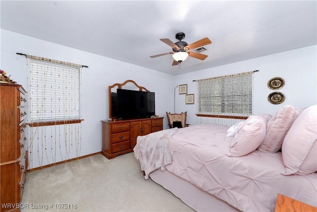 bedroom with light carpet and ceiling fan