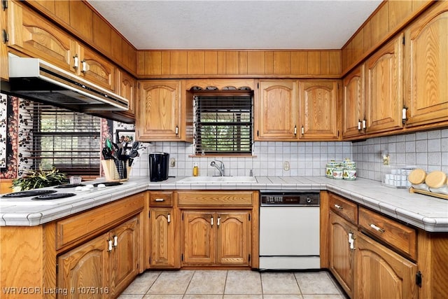 kitchen featuring tile counters, sink, white appliances, decorative backsplash, and light tile patterned flooring