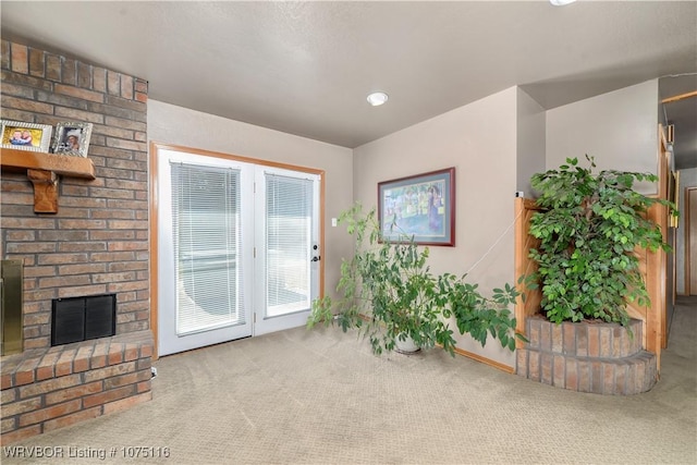 interior space featuring carpet flooring and a brick fireplace