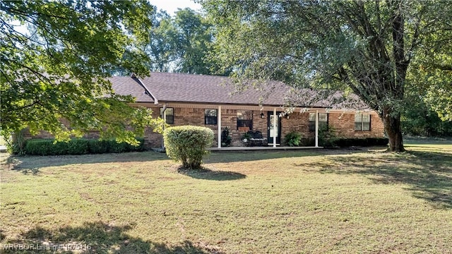 ranch-style home with a front lawn