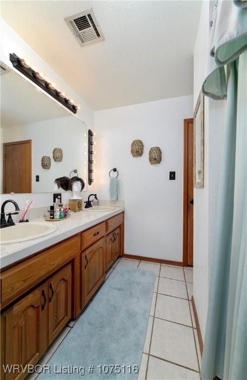 bathroom with tile patterned floors and vanity