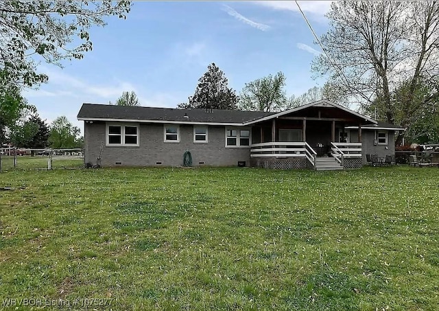 rear view of house featuring a yard