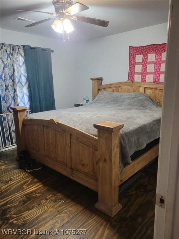 bedroom featuring ceiling fan and dark hardwood / wood-style flooring