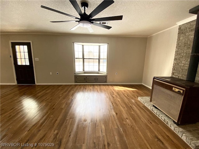 unfurnished living room featuring radiator heating unit, ornamental molding, ceiling fan, a textured ceiling, and hardwood / wood-style floors