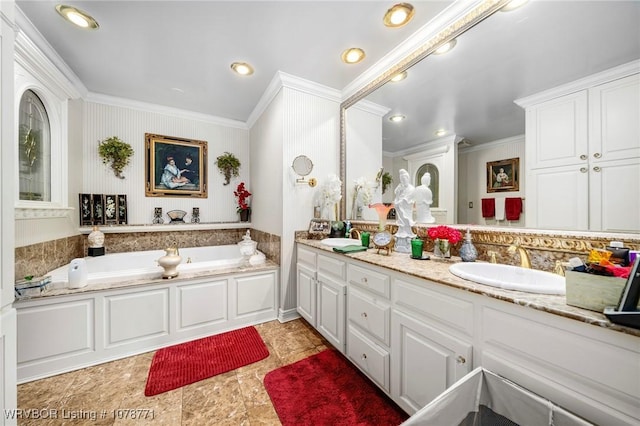 bathroom featuring ornamental molding, a bathtub, and vanity