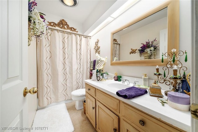 bathroom with tile patterned flooring, vanity, and toilet