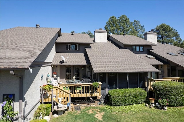 back of house with a yard and a deck