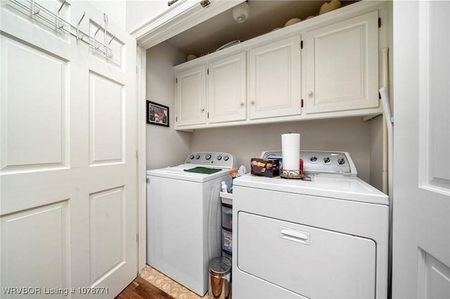 washroom featuring cabinets and separate washer and dryer