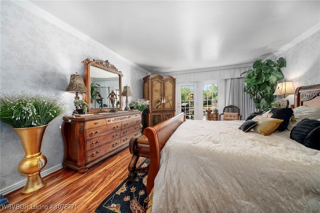 bedroom with french doors, ornamental molding, hardwood / wood-style floors, and access to outside