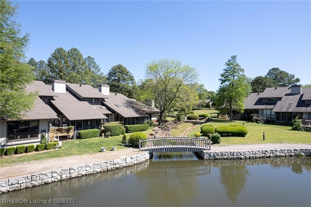 exterior space with a water view and a yard