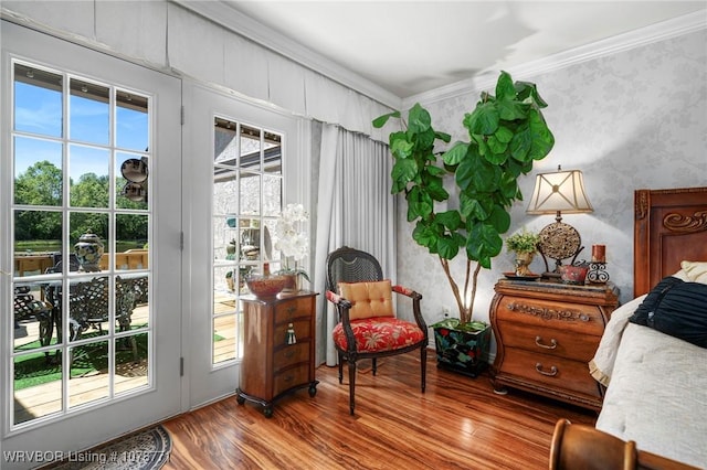 interior space with hardwood / wood-style floors and ornamental molding