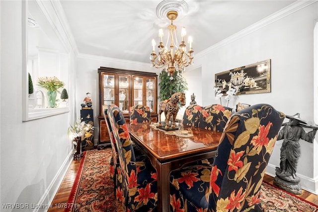 dining room featuring crown molding, wood-type flooring, and a chandelier