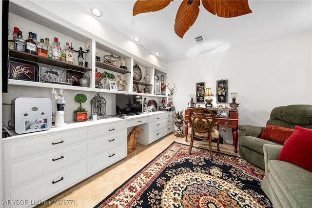 interior space featuring ceiling fan and built in desk