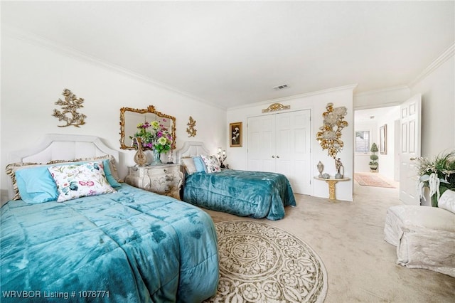 bedroom featuring ornamental molding, carpet, and a closet