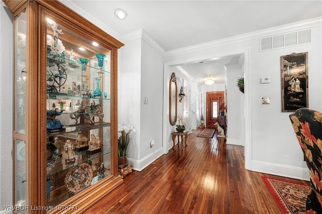 hall featuring crown molding and dark hardwood / wood-style flooring