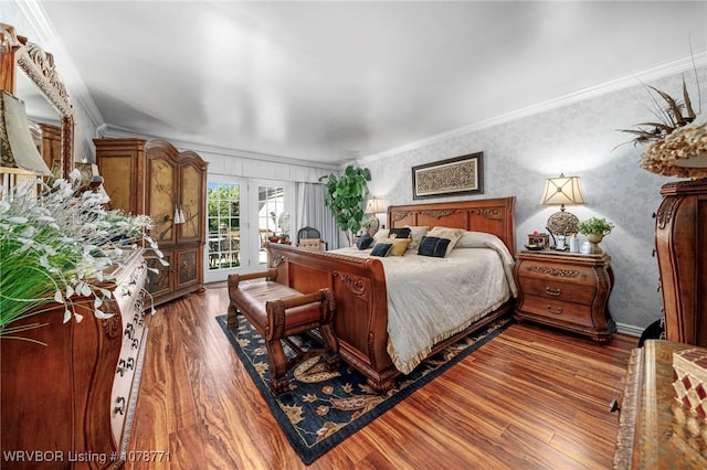 bedroom featuring dark hardwood / wood-style flooring, access to outside, and ornamental molding