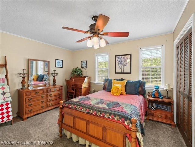 bedroom featuring a textured ceiling, carpet floors, multiple windows, and a closet