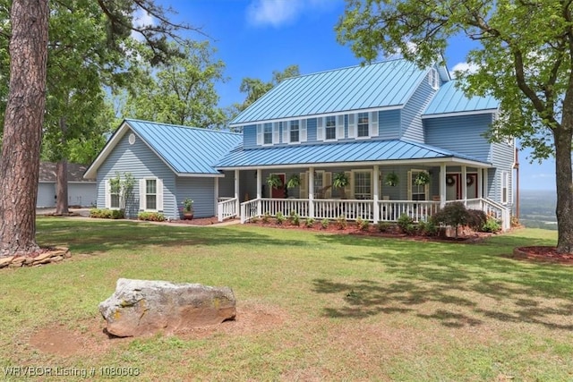 exterior space with covered porch, a yard, a standing seam roof, and metal roof