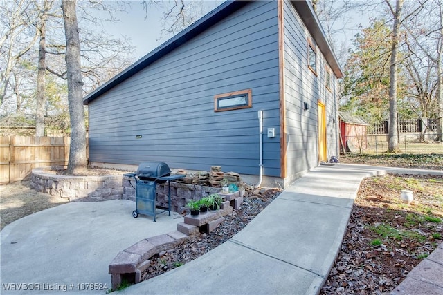 view of home's exterior featuring a patio and fence