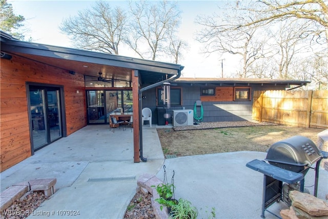 rear view of property with a patio area, fence, and ac unit