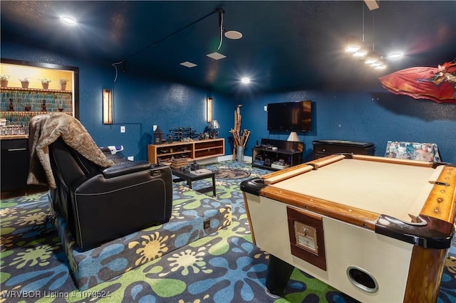 home theater room featuring pool table and a textured wall