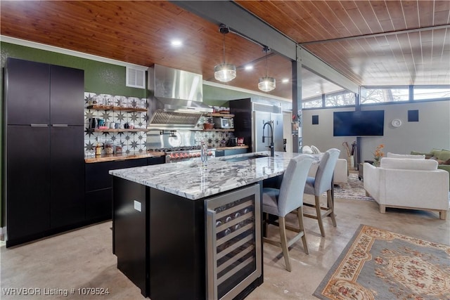 kitchen featuring visible vents, beverage cooler, lofted ceiling with beams, exhaust hood, and dark cabinets