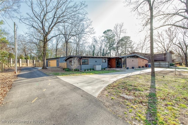 view of front of property with fence and driveway