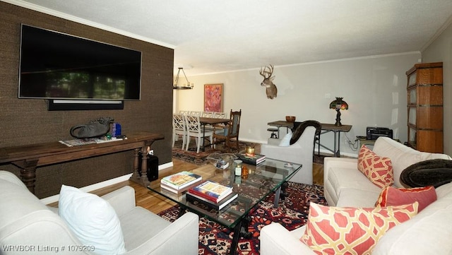 living room with baseboards, ornamental molding, and wood finished floors