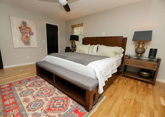 bedroom featuring light wood finished floors, a ceiling fan, and baseboards