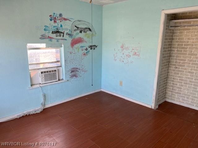 empty room featuring dark hardwood / wood-style floors and cooling unit