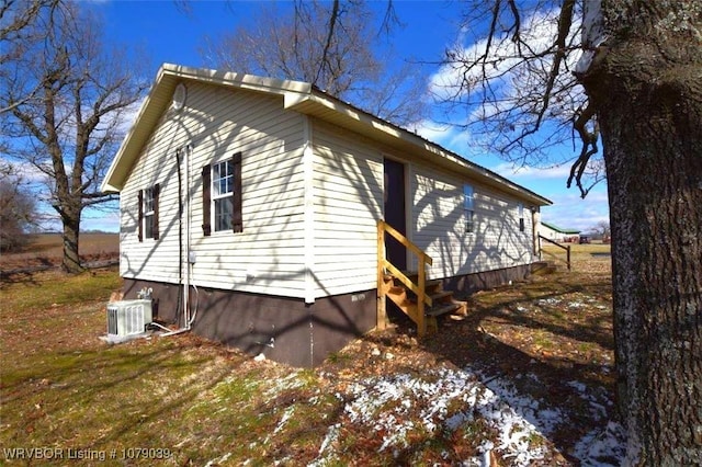 view of side of home with central AC unit