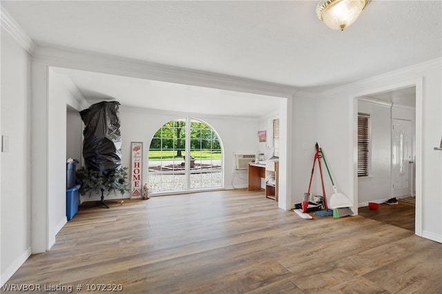 interior space with hardwood / wood-style floors and crown molding