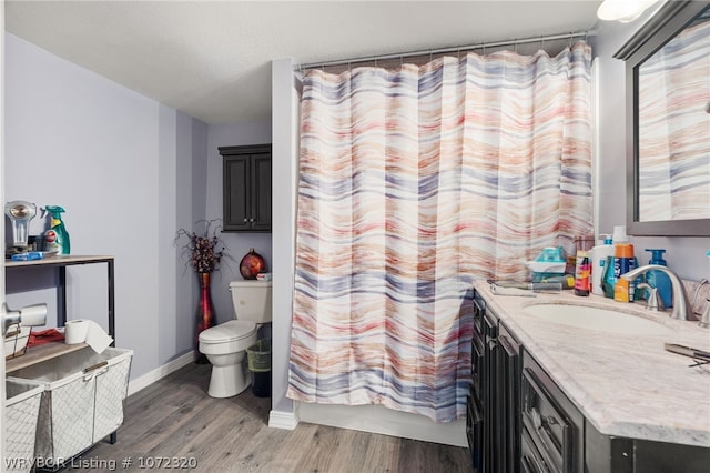 bathroom featuring a shower with curtain, vanity, a textured ceiling, wood-type flooring, and toilet