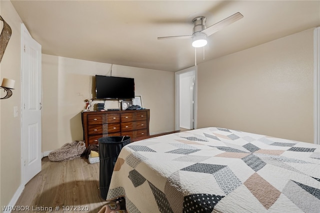 bedroom with ceiling fan and light hardwood / wood-style flooring