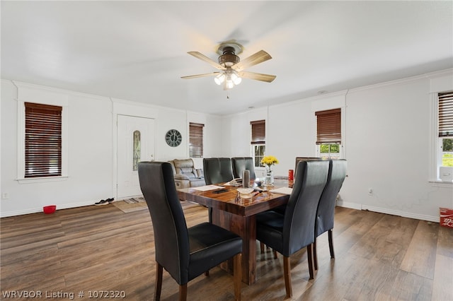 dining area with ceiling fan, crown molding, and wood-type flooring