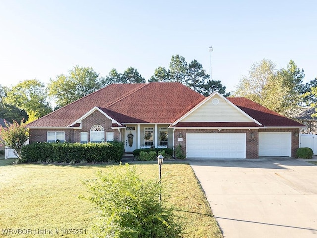 view of front facade with a garage and a front lawn