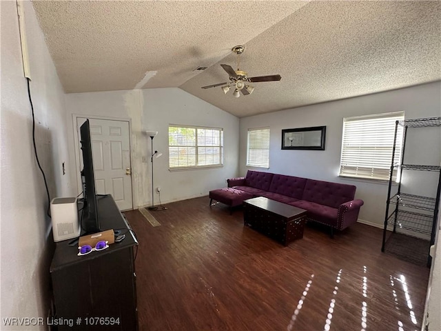 living room featuring a textured ceiling, ceiling fan, dark wood-type flooring, and lofted ceiling