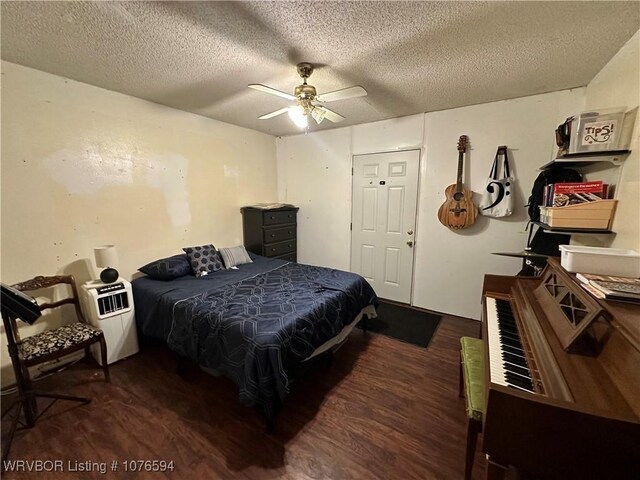 bedroom featuring ceiling fan, dark hardwood / wood-style floors, and a textured ceiling