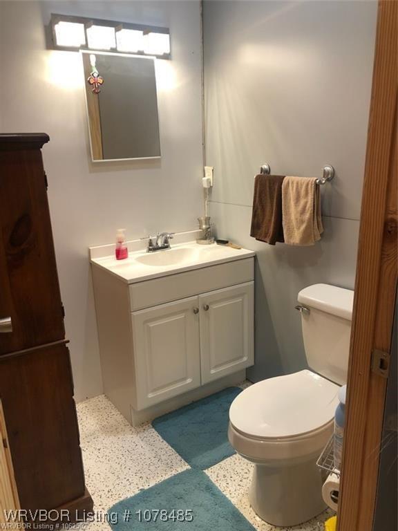 bathroom featuring vanity and toilet